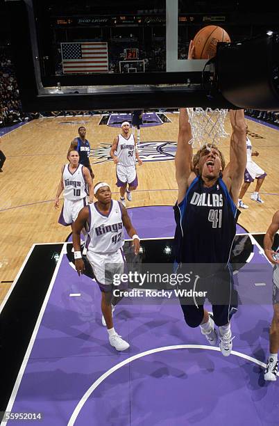 Dirk Nowitzki of the Dallas Mavericks takes the ball to the basket past Bonzi Wells of the Sacramento Kings during a preseason game at Arco Arena on...