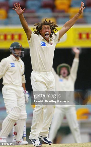 Andrew Symonds of the Bulls takes the first wicket of the second innings during day three of the Pura Cup match between the Queensland Bulls and...