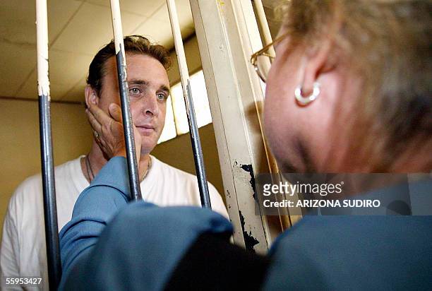 One of nine Australian drugs smuggling suspect, Martin Stephens , talks to his mother at a Denpasar court detention house before his trial in the...