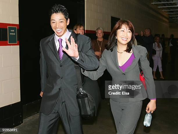 Outfielder So Taguchi of the St. Louis Cardinals leaves Game Five of the National League Championship Series with his wife after defeating the...