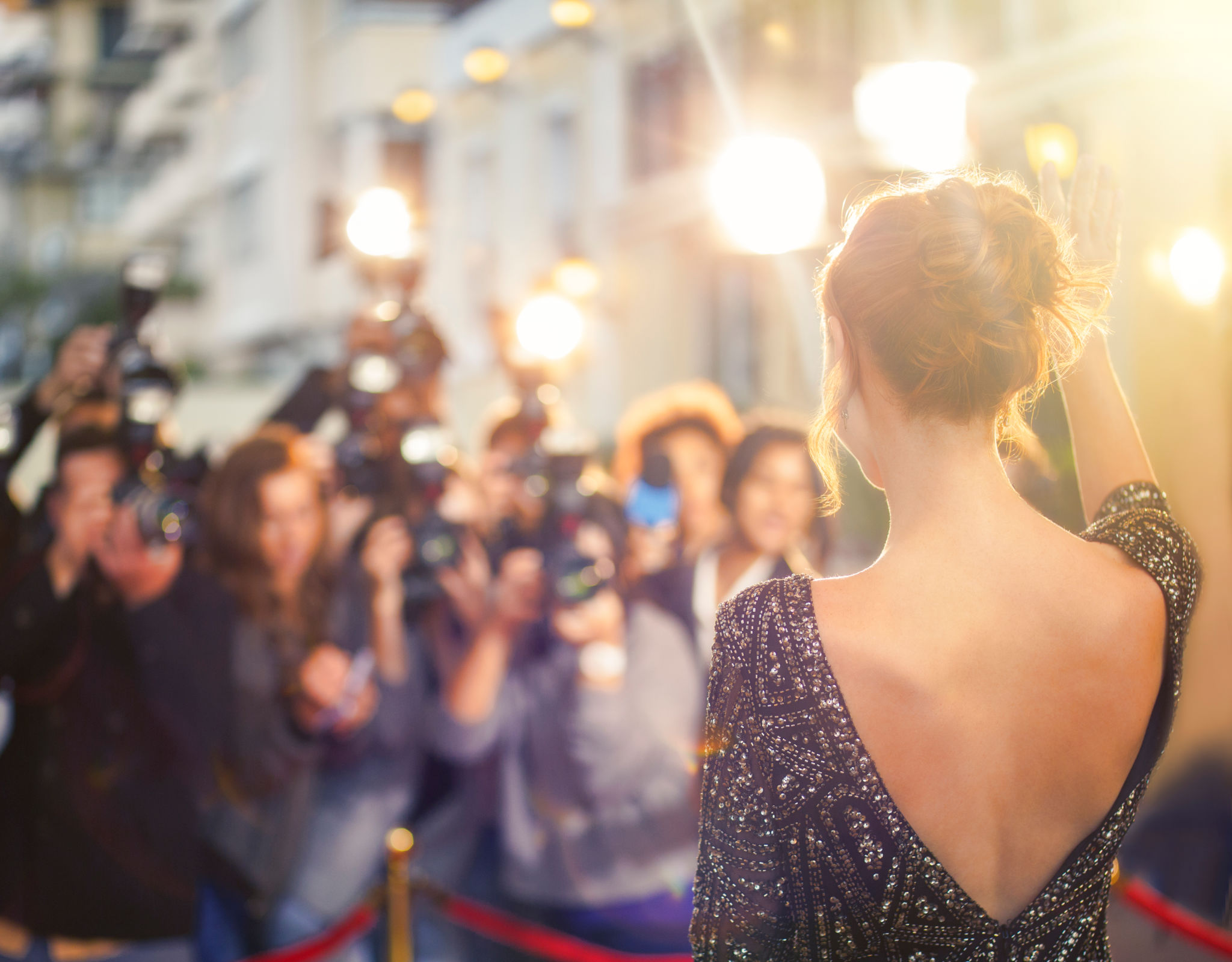 Celebrity waving at paparazzi photographers at event Celebrity waving at paparazzi photographers at event