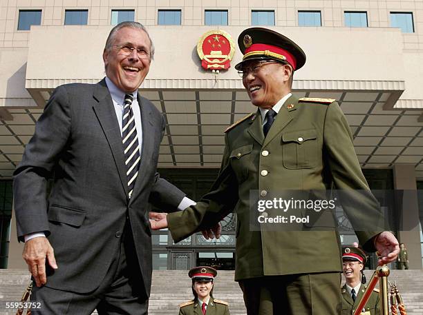 Defense Secretary Donald Rumsfeld and Chinese Defense Minister Cao Gangchuan laugh as they attend a welcoming ceremony at the Chinese Defense...