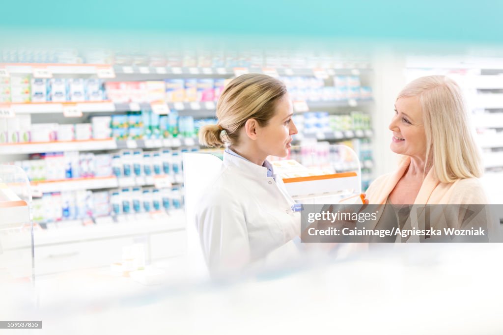 Pharmacist and customer talking in pharmacy