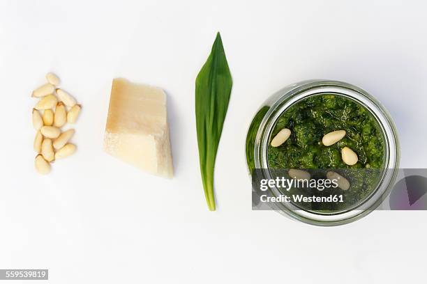 homemade ramson pesto, parmesan, leaf and pine nuts on wood - pine nut stock pictures, royalty-free photos & images