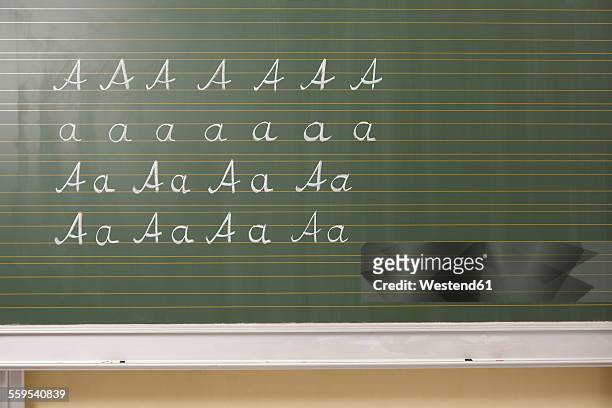 variations of letter a at blackboard in classroom - schultafel stock-fotos und bilder