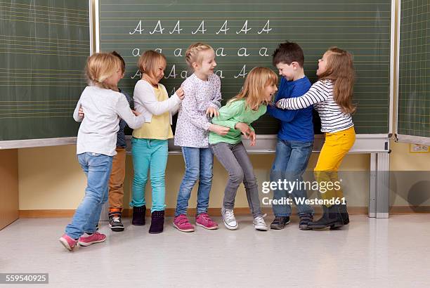 playful pupils in classroom - naughty kids in classroom stock pictures, royalty-free photos & images