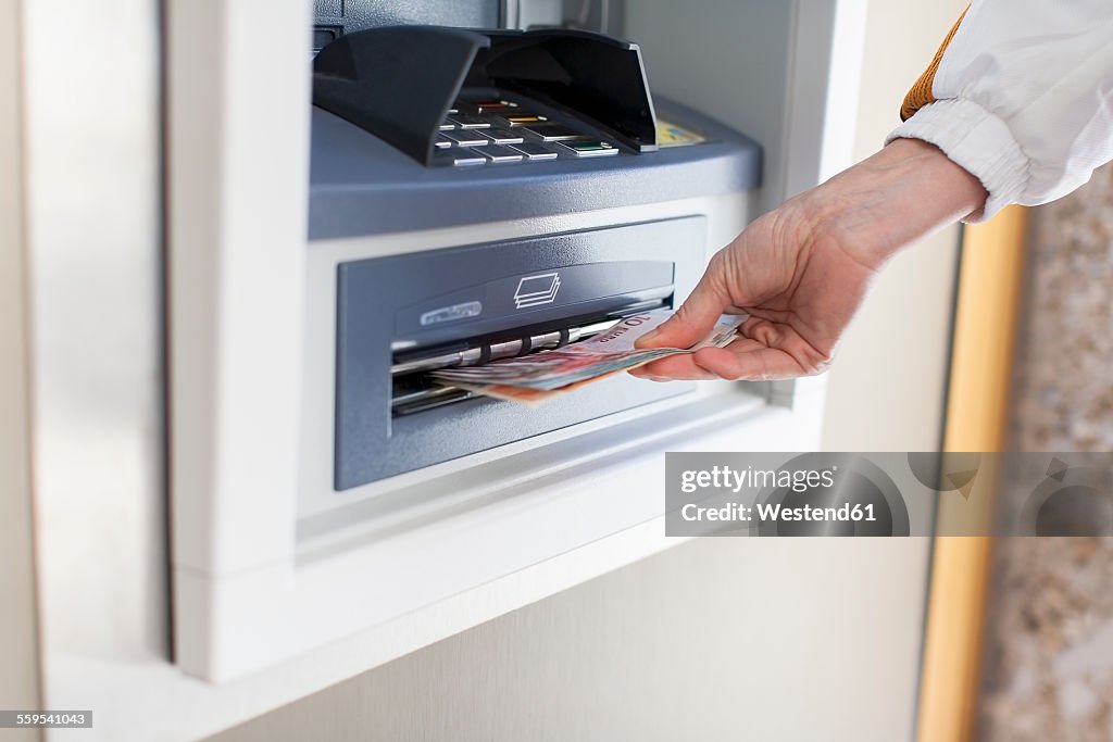 Woman at cash machine
