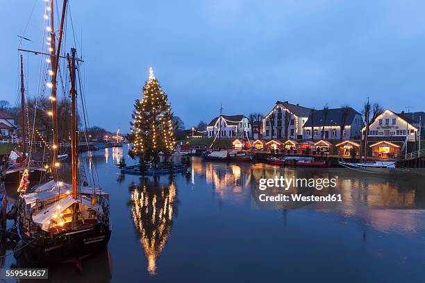 germany, lower saxony, carolinensiel, harbor with christmas illumination - ostfriesland stock-fotos und bilder
