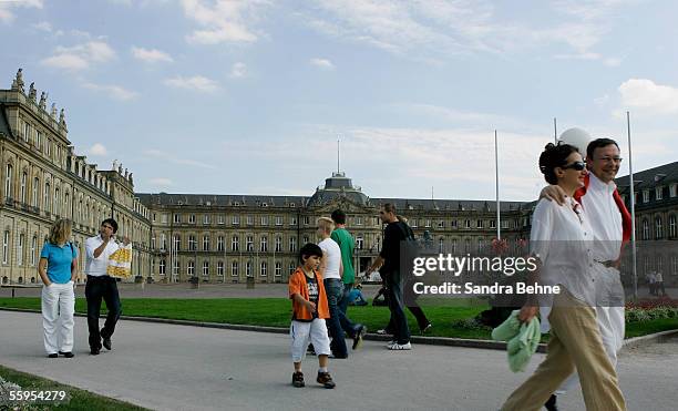 People take a walk in front of the New Palace on September 25, 2005 in Stuttgart, Germany. A construction time of 60 years and four architects were...