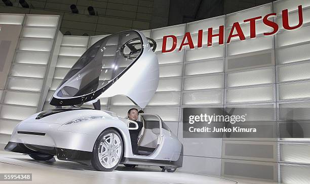 Teruyuki Minoura, president of Daihatsu Motor Co., Ltd introduces the company's fuel concept car UFE-III, during the preview for the 39th Tokyo Motor...