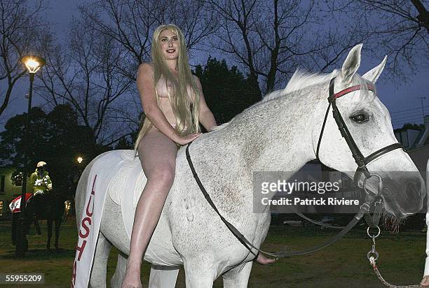 Model Amber Kenny rides Christmas the horse as Lady Godiva to attend the opening of LushART Gallery in Surry Hills on October 19, 2005 in Sydney,...