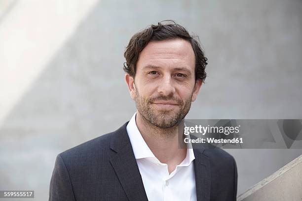 portrait of businessman in a modern building - grey suit stock pictures, royalty-free photos & images