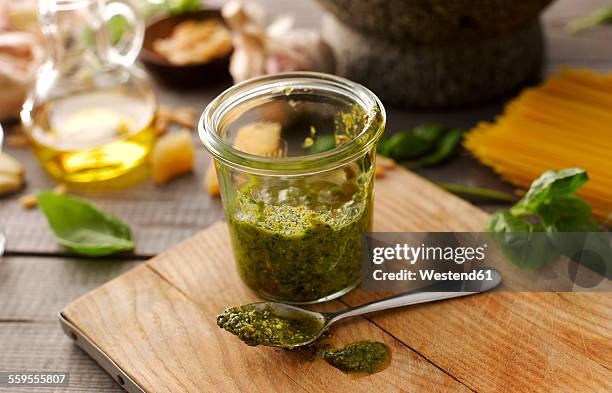 preserving jar of homemade basil pesto - pesto imagens e fotografias de stock