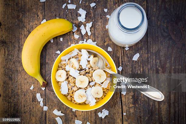 bowl of granola, banana slices and coconut flakes - milk bottles stock pictures, royalty-free photos & images