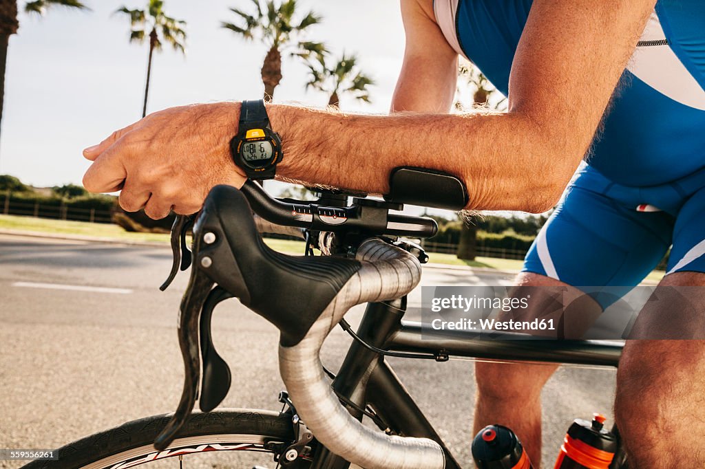 Spain, Mallorca, Sa Coma, triathlet training on bicycle, close-up