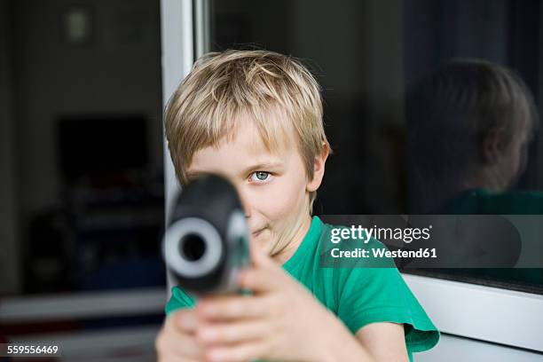 boy playing with toy gun - toy gun stock pictures, royalty-free photos & images