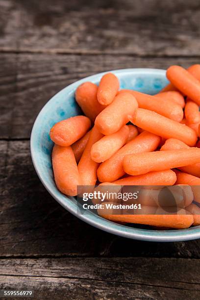 dish of baby carrots - ベビーキャロット ストックフォトと画像
