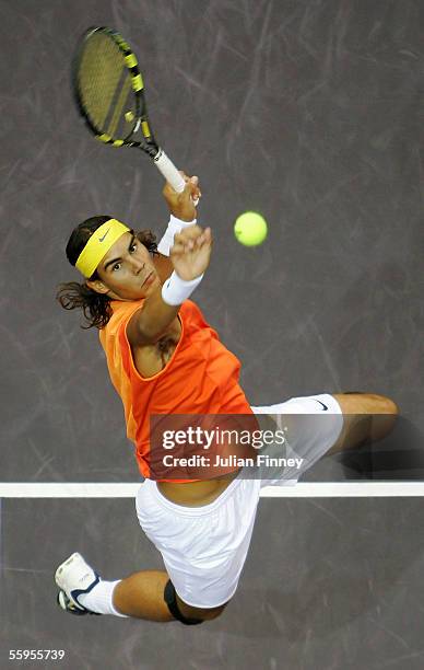 Rafael Nadal of Spain jumps high in the air to play a spectacular smash against Victor Hanescu of Romania in the second round of the ATP Madrid...