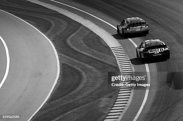 Dale Earnhardt Jr driving the Budweiser Chevrolet leads Ryan Newman in the Penske Racing Alltel Dodge during the NASCAR Nextel Cup Series Brickyard...