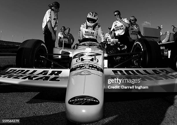 Sarah Fisher climbs aboard the Dollar General Stores Sarah Fisher Racing Dallara Honda during qualifying for the IndyCar Series Meijer Indy 300 on...