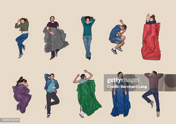 group of people lying down sleeping, aerial view - laying foto e immagini stock