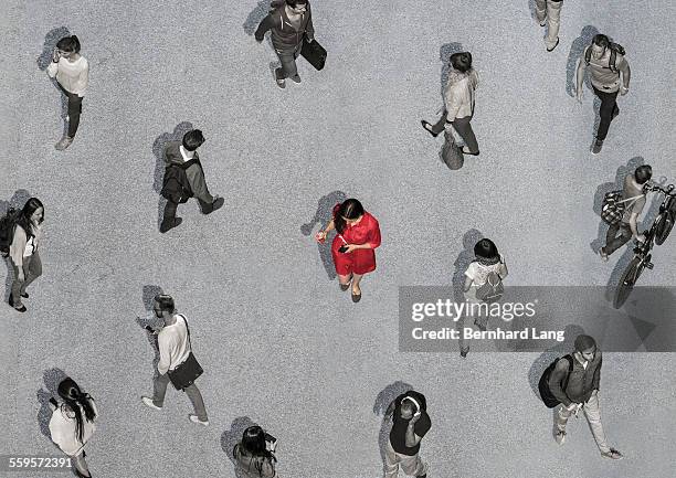 one colored woman among colorless people - gegensatz stock-fotos und bilder