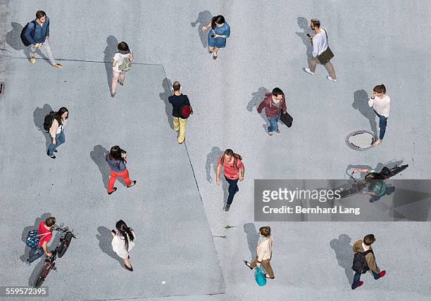 people walking on asphalt underground, aerial view - elevated view stock-fotos und bilder