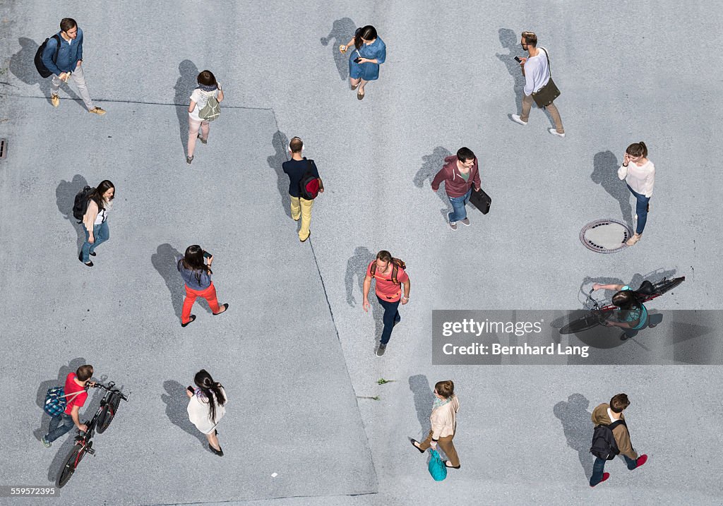 People walking on asphalt underground, Aerial View