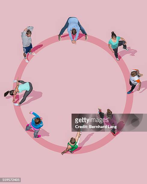 group of young people strechting, aerial views - woman standing exercise stock-fotos und bilder