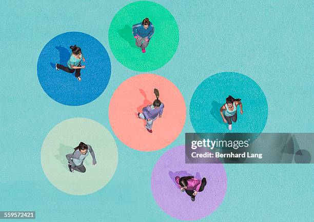 six young women running, aerial views - sport blue background stock-fotos und bilder