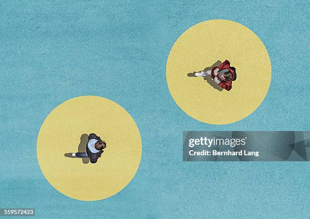 two men crossing, aerial view - social distancing stockfoto's en -beelden