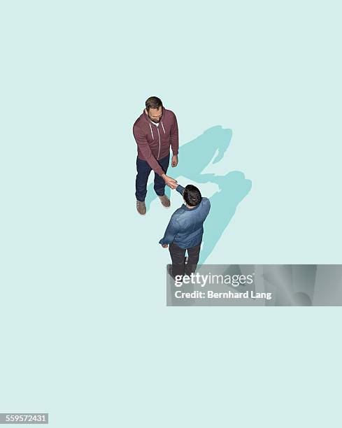 two men shaking hands, aerial view - contact color background stock-fotos und bilder