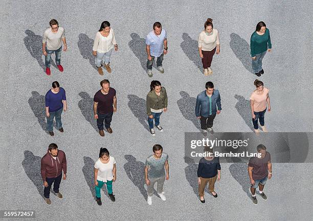 people standing on asphalt ground, aerial views - large group of people overhead stock pictures, royalty-free photos & images