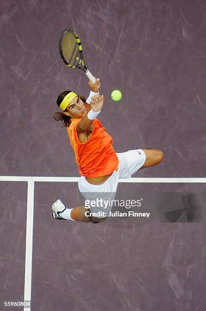 Rafael Nadal of Spain jumps high in the air to play a spectacular smash against Victor Hanescu of Romania in the second round of the ATP Madrid...