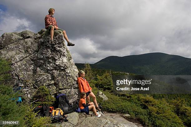 three children pause during a hiking adventure in new england. - appalachian trail fotografías e imágenes de stock