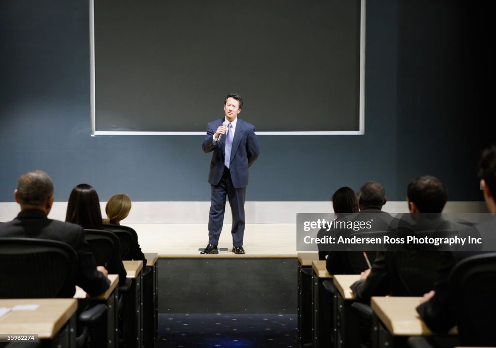 Businessman talking in auditorium