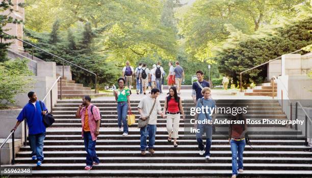 college students descending stairs - campus stockfoto's en -beelden