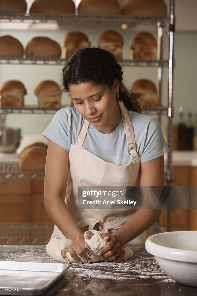 Woman kneading bread dough