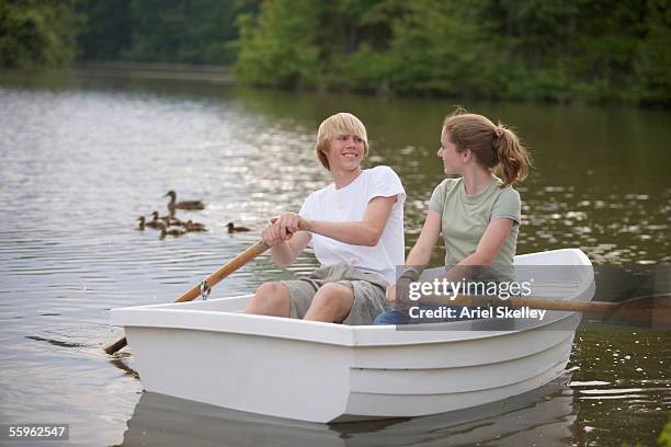 teen couple rowing boat - rowboat bildbanksfoton och bilder