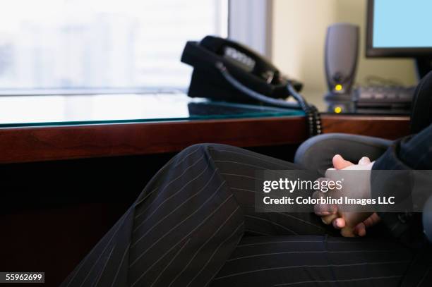 businesswoman sitting at desk - pinstripe fotografías e imágenes de stock