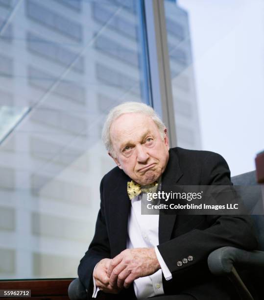 senior businessman with pensive expression - portrait of business man looking surprised stock-fotos und bilder