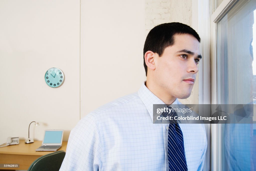 Businessman looking out window