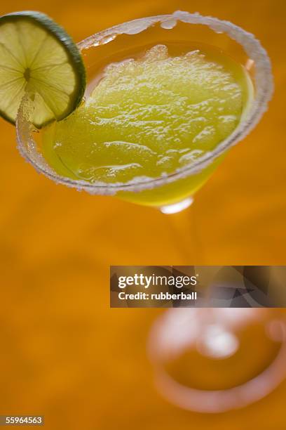 close-up of a crush ice in a glass of martini - tangerine martini stock pictures, royalty-free photos & images