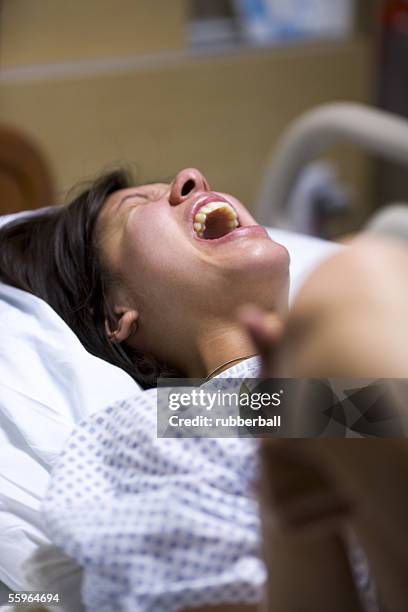 high angle view of a female patient showing uncomfortable expression - moms crying in bed stock pictures, royalty-free photos & images