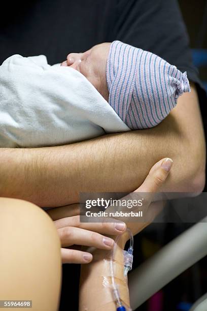 close-up of a father carrying his newborn baby girl - baby arrival stock pictures, royalty-free photos & images