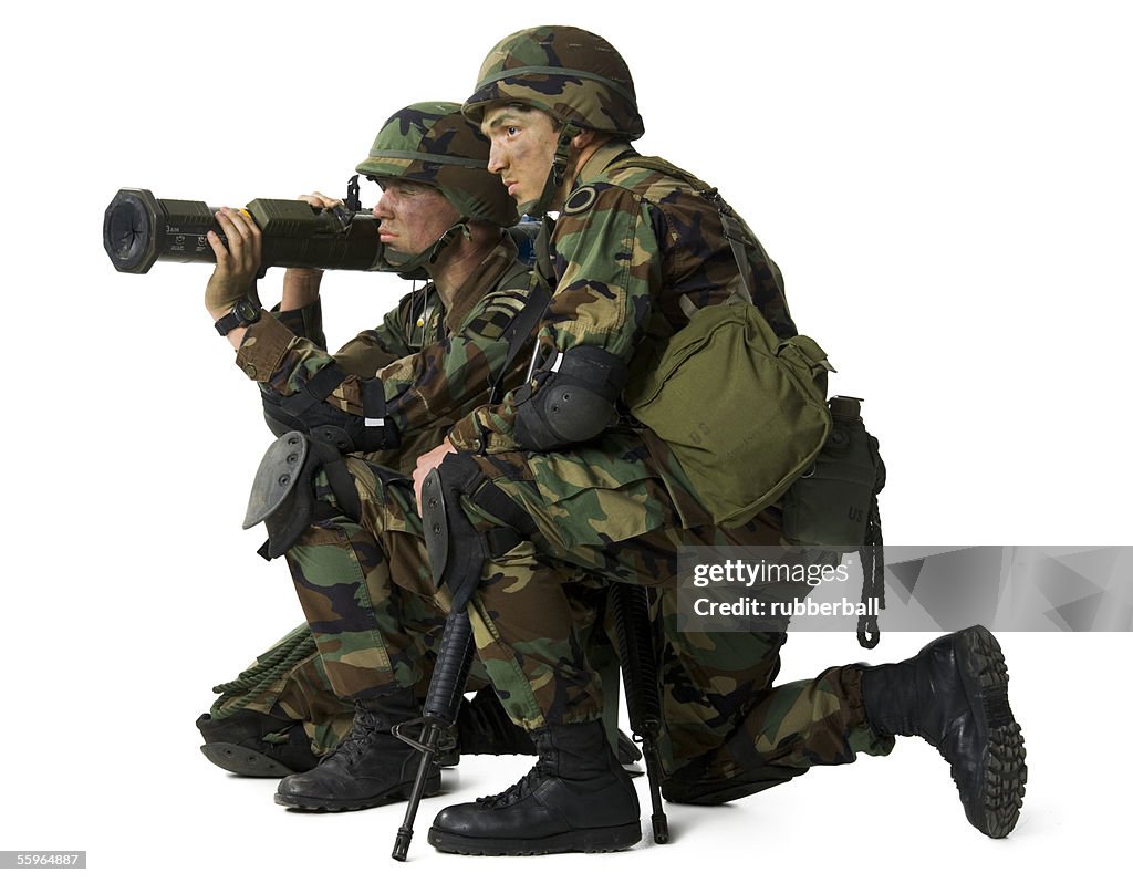 Side profile of two soldiers holding a grenade launcher