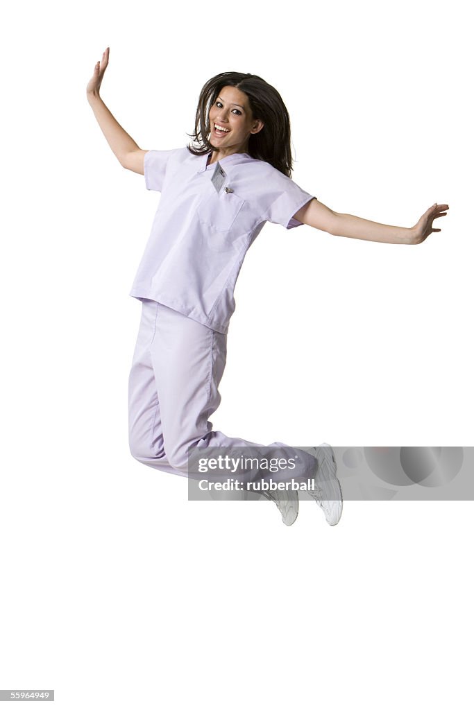Portrait of a female nurse jumping