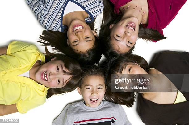 high angle view of a mother with her four children - girl 11 12 laughing close up foto e immagini stock