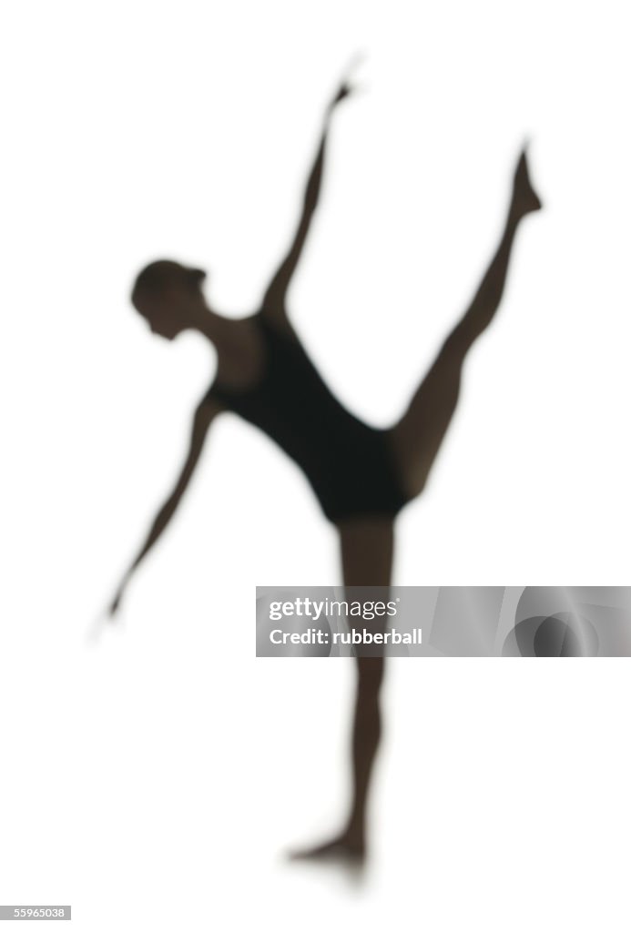 Silhouette of a young woman doing rhythmic gymnastics