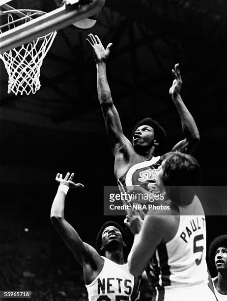 Moses Malone of the Utah Stars drives to the basket for a layup against the New York Nets during an ABA game at the Nassau Veterans Memorial Coliseum...